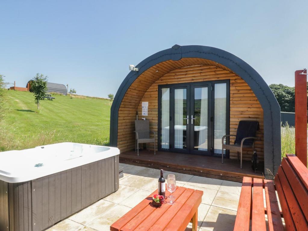 a gazebo with a hot tub on a patio at Rowan in Ulverston