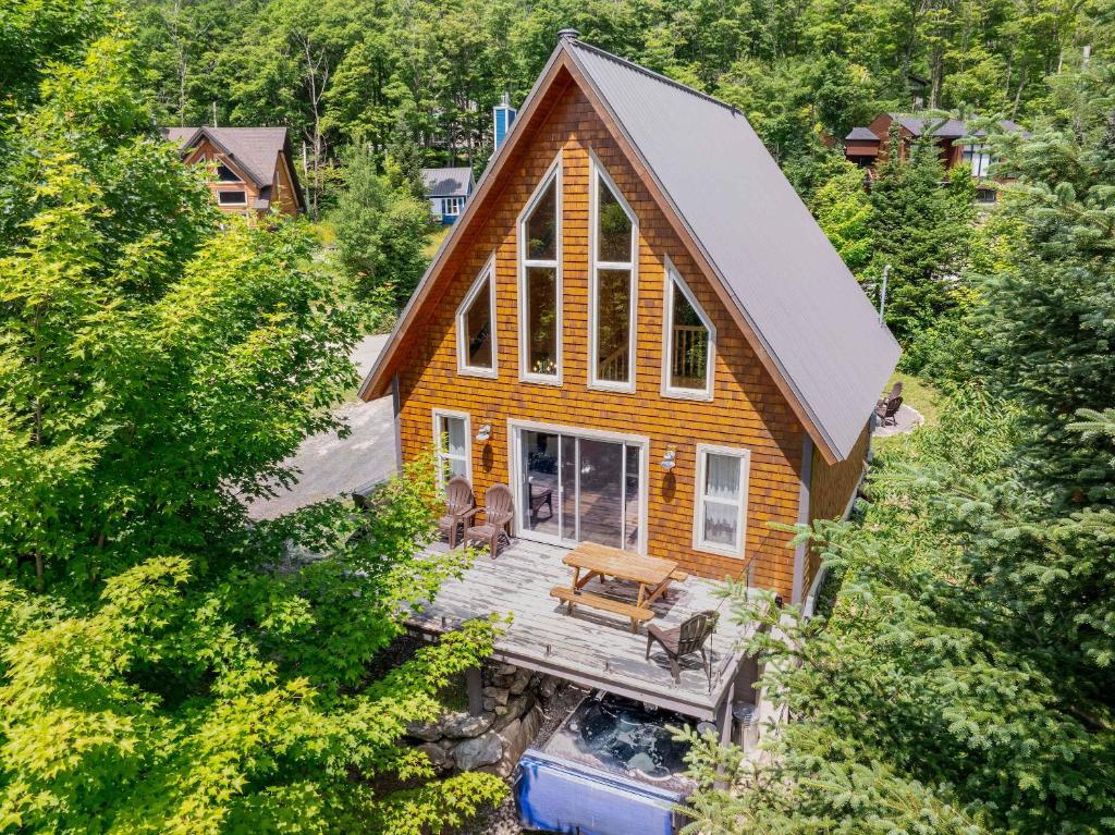 an overhead view of a house with a wooden deck at Spa Outdoor & Adventure - LEnigmasud in Saint-Philémon