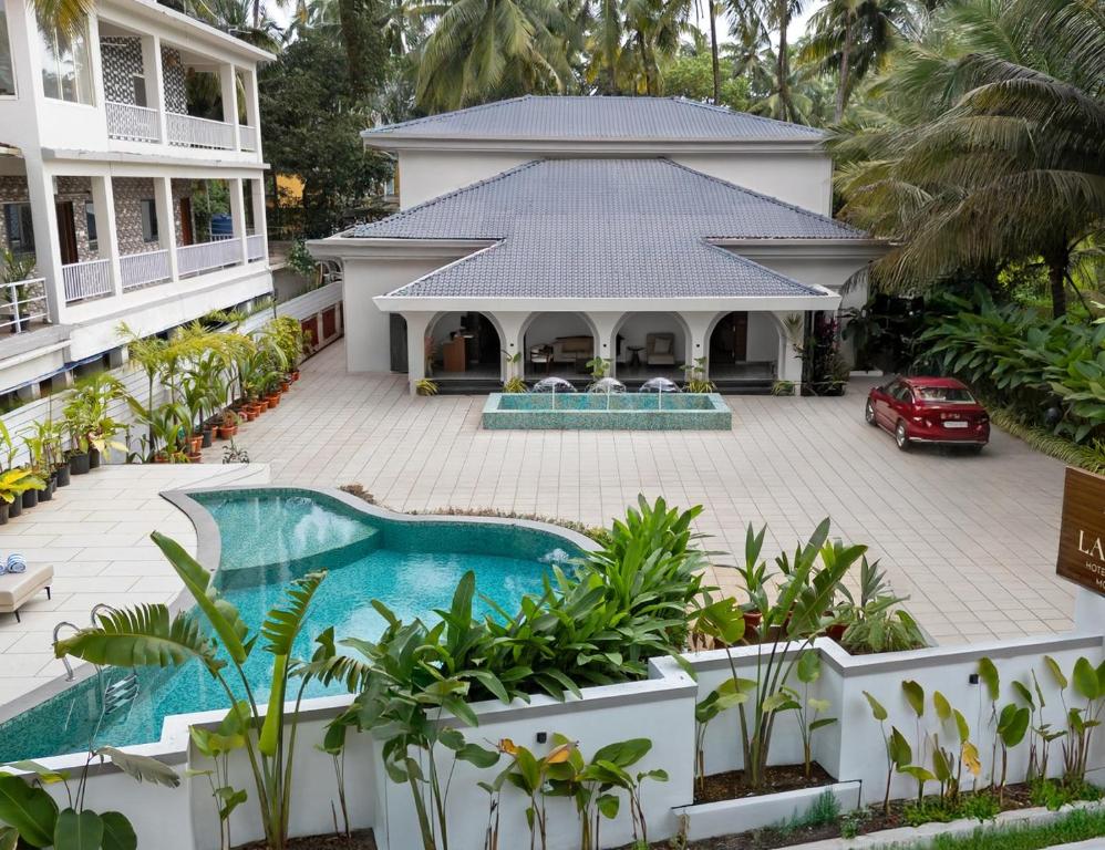 an aerial view of a house with a swimming pool at Lamrin Morjim Goa in Morjim