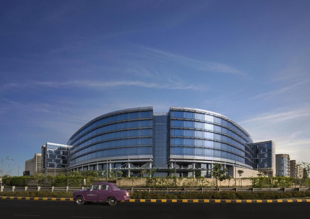 a pink car parked in front of a building at Andaz Delhi, by Hyatt in New Delhi