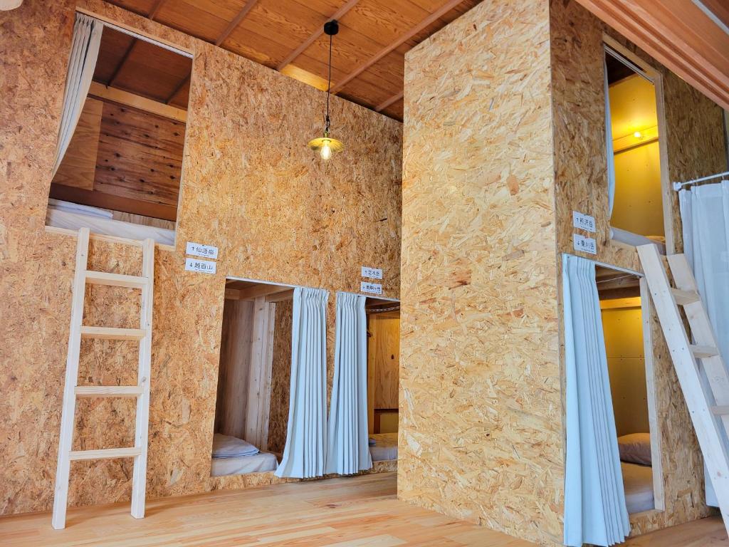 a room with multiple bunk beds in it at おかえりヒュッテ in Komagane