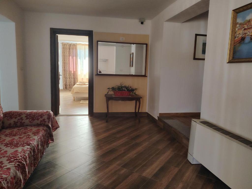 a living room with a couch and a table at Casa Alma in Paşcani