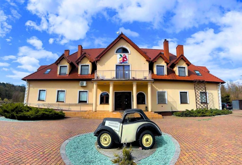 a house with a small car in front of it at Bukowa Przystań Barlinek in Barlinek
