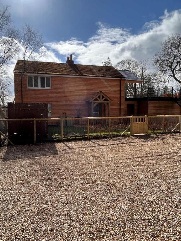 a house with a fence in front of it at Badgers Bolt in Avington