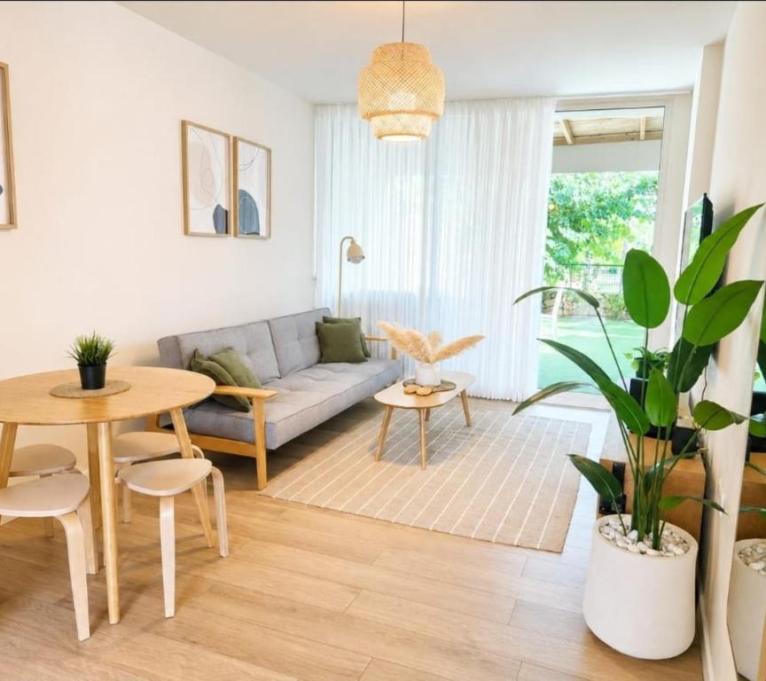 a living room with a couch and a table at סי מיה - דירות יוקרתיות במתחם נאות גולף in Caesarea