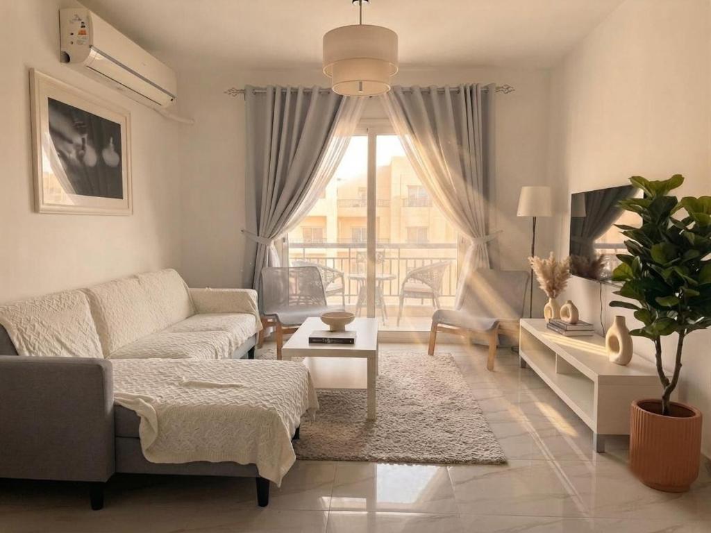 a living room with a couch and a table at the LOFT - Elite Residence in Cairo