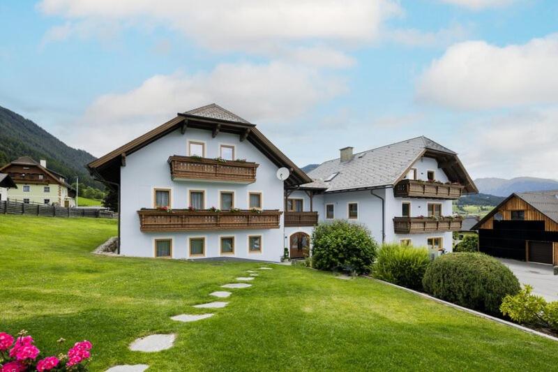 a large white house with a green lawn at Grillhofer - Slow Living Apartments -LUNGAUCard inkludiert in Mauterndorf