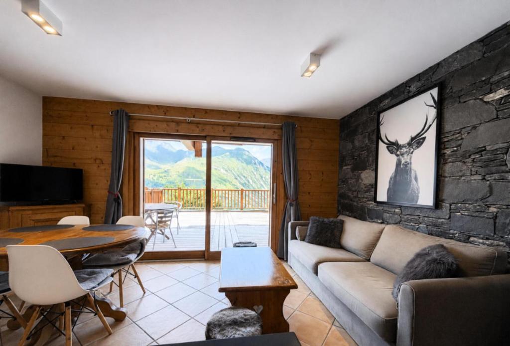 a living room with a couch and a table at Chalet Adele - Appartement 4 personnes situé en bord de piste St Martin de Belleville MAE-5684 in Saint-Martin-de-Belleville