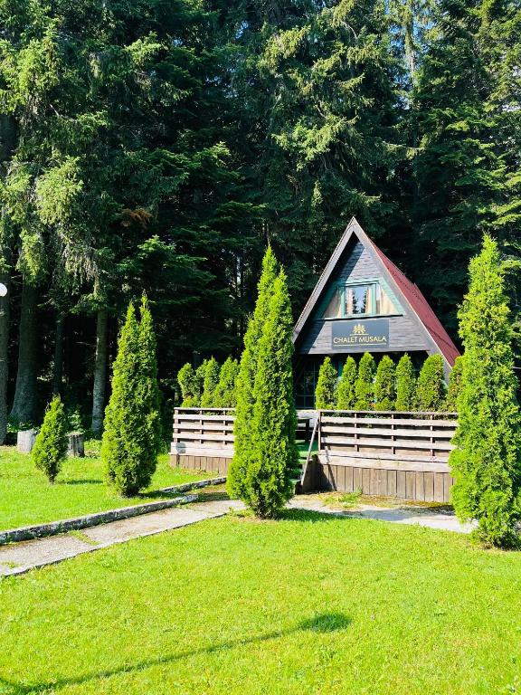 a building with a sign on it in a park at Chalet Musala in Borovets