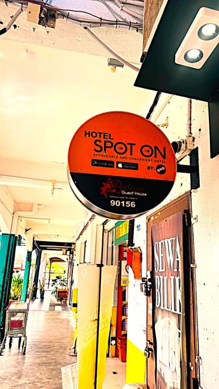 a sign for a hotel spot on a store at Bidara Guest House in Kampong Sungai Baru Tengah
