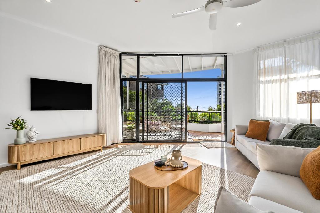 a living room with a couch and a tv at Coolum Beach Apartment, 2 Bed 2 Bath, Pool in Coolum Beach