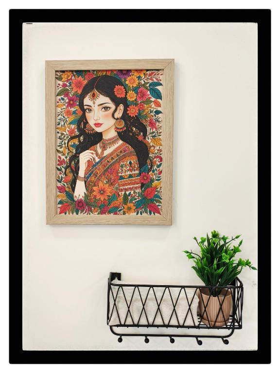 a painting of a woman on a wall with a plant at 1 BHK by Agartha Atithya in Hyderabad