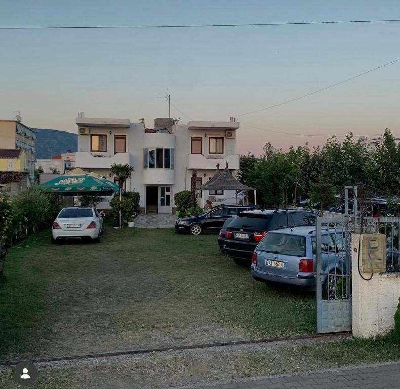a group of cars parked in front of a house at ApartHotel Fahria Velipoje in Velipojë