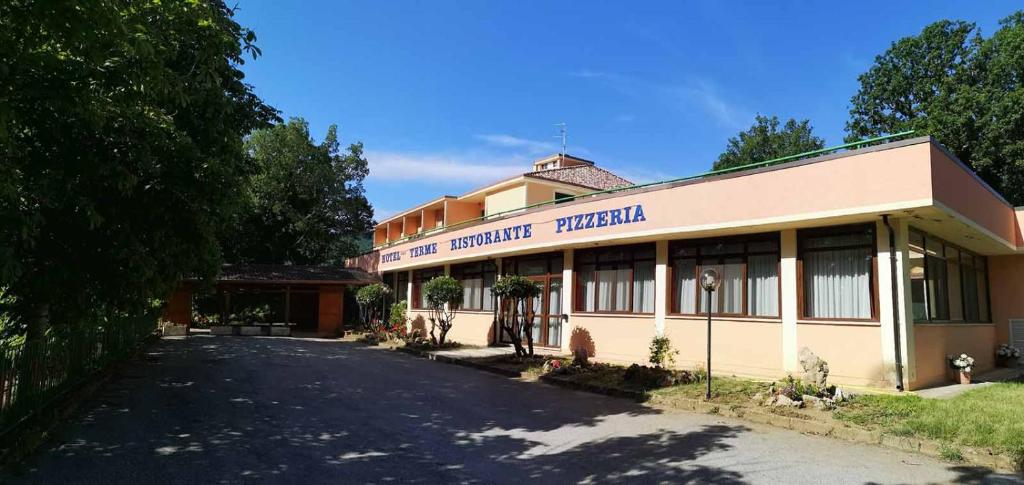 a building with a sign that reads the university hospital at Hotel Terme in Tempone