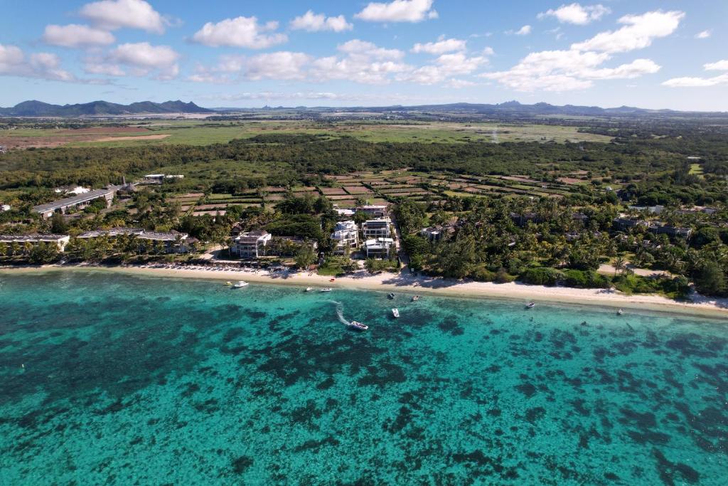 an aerial view of a beach with boats in the water at Summer beachfront apartment in Belle Mare