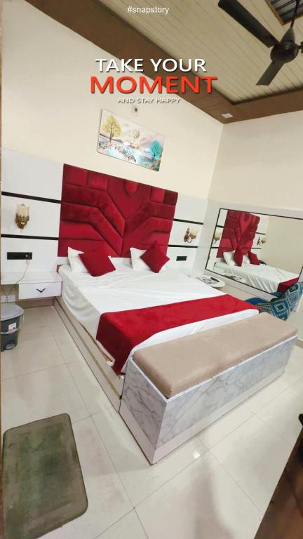 a bedroom with a bed with a sign that reads take your moment at The Eros in Sonīpat