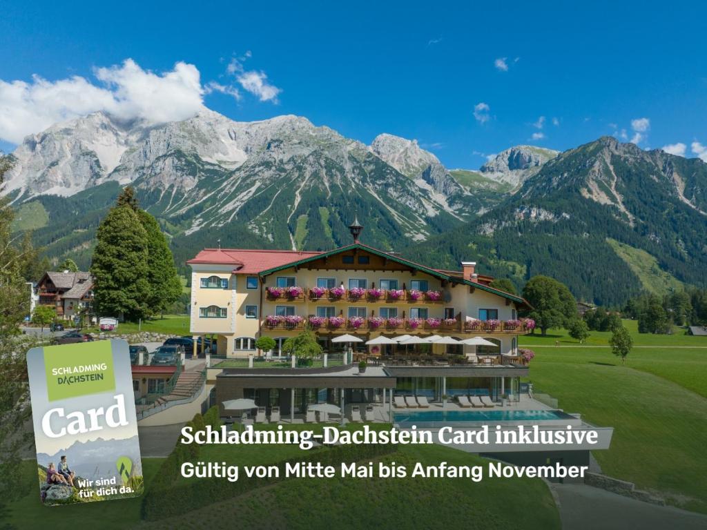 a rendering of a hotel with mountains in the background at Hotel Ennstalerhof in Ramsau am Dachstein