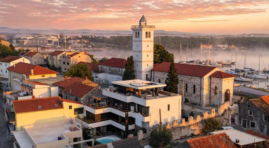 a view of a city with a clock tower at BASIC MANSION plus with swimming pool & free parking in Šibenik