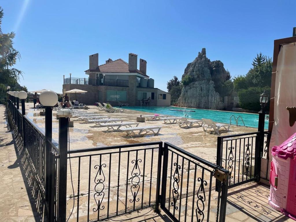 a resort with a swimming pool and a house at Lesnasr chalet apartments in Al ‘Aqabah