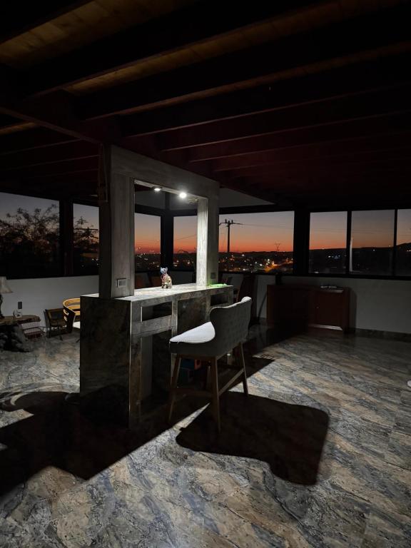 a room with a chair and a desk with windows at Cabaña Lakshmi in El Pescador