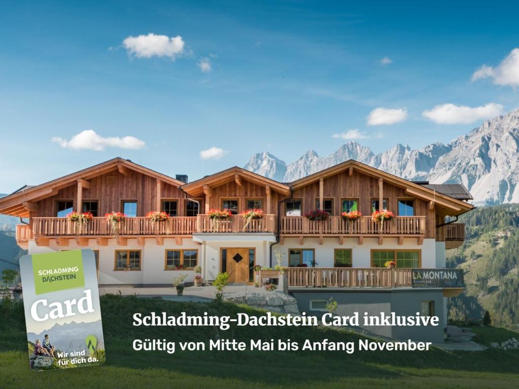 a house with a balcony with mountains in the background at La Montana Ski & Hiking LODGE in Schladming