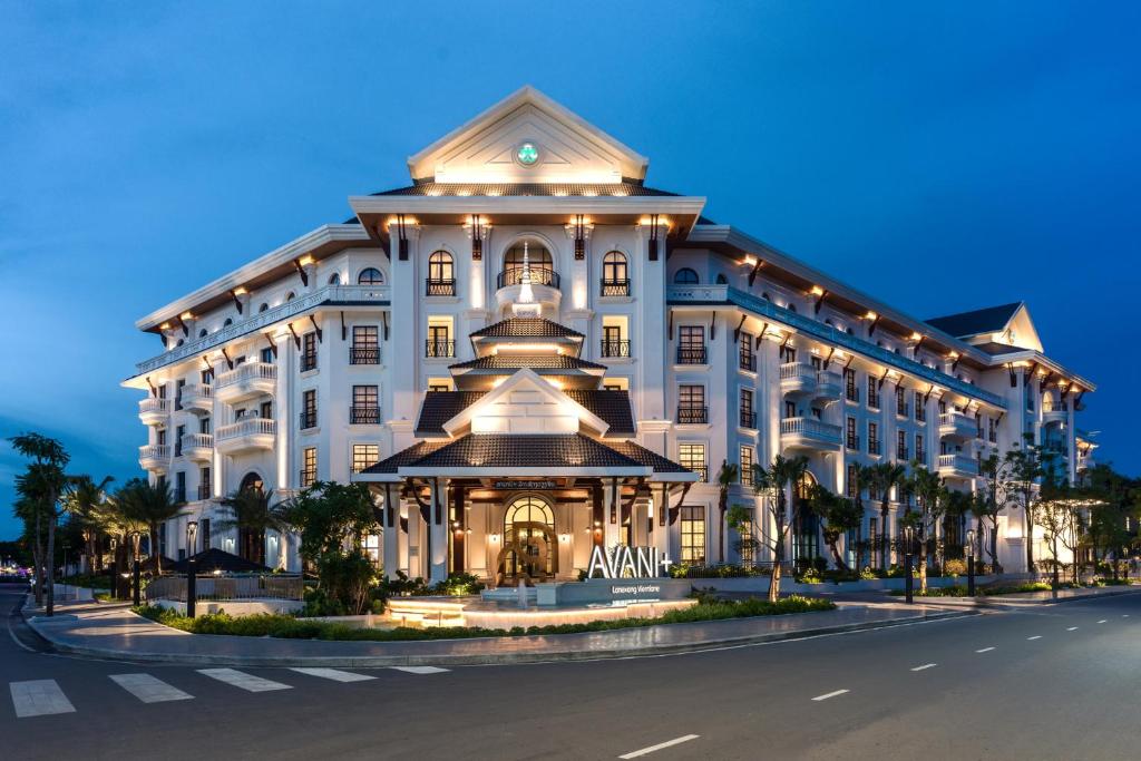 a large white building with a clock on it at Avani Plus Lanexang Vientiane Hotel in Vientiane