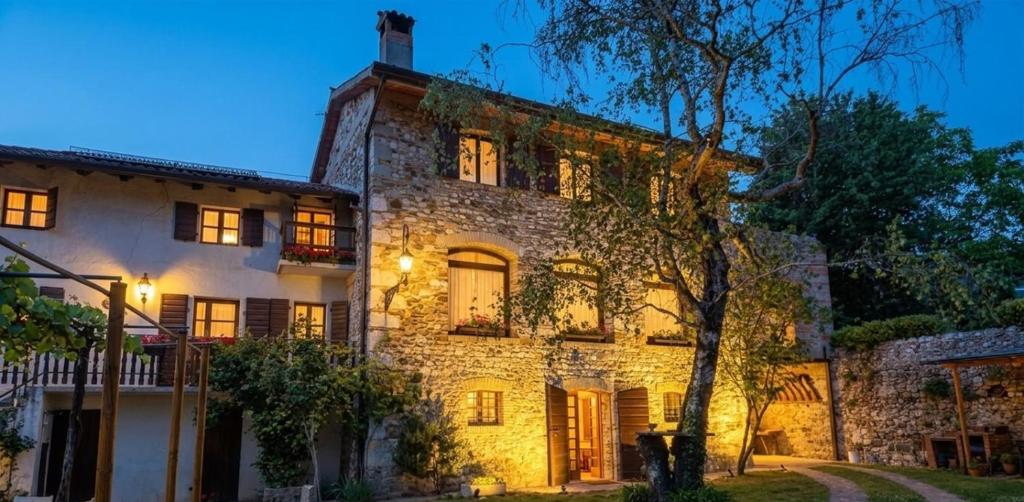 an old stone house at night at Ca'Bastian-Guest House in Moruzzo