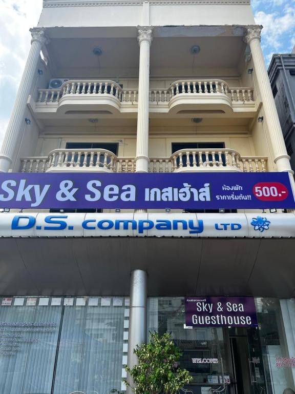 a building with a sign on the side of it at Sky&Sea Guesthouse Cha am TK in Cha Am