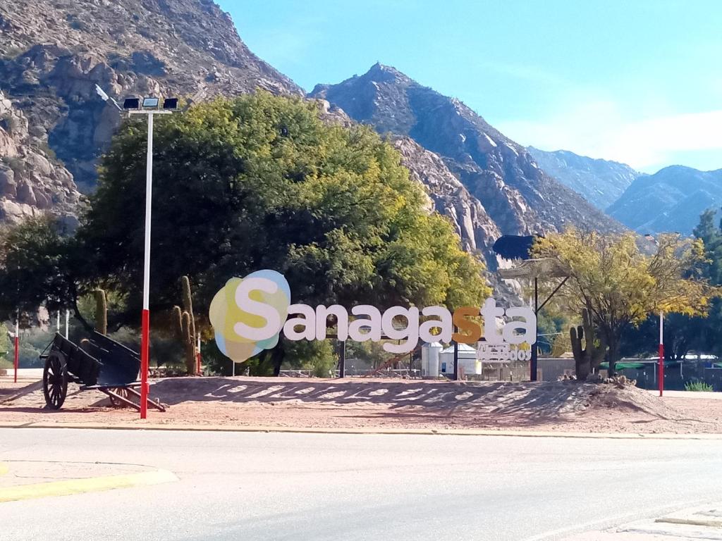 a sign for santaggia with mountains in the background at Cabañita La Paz Villa Sanagasta in Villa Bustos