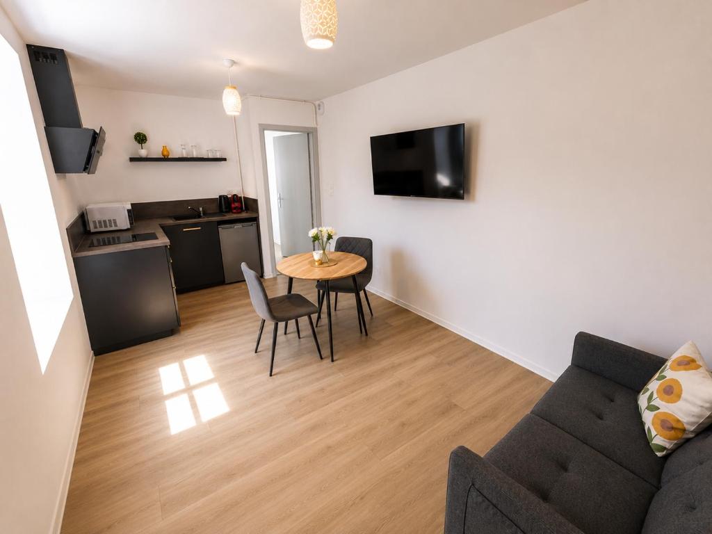 a living room with a couch and a table at Le Clos d'Ingersheim in Ingersheim