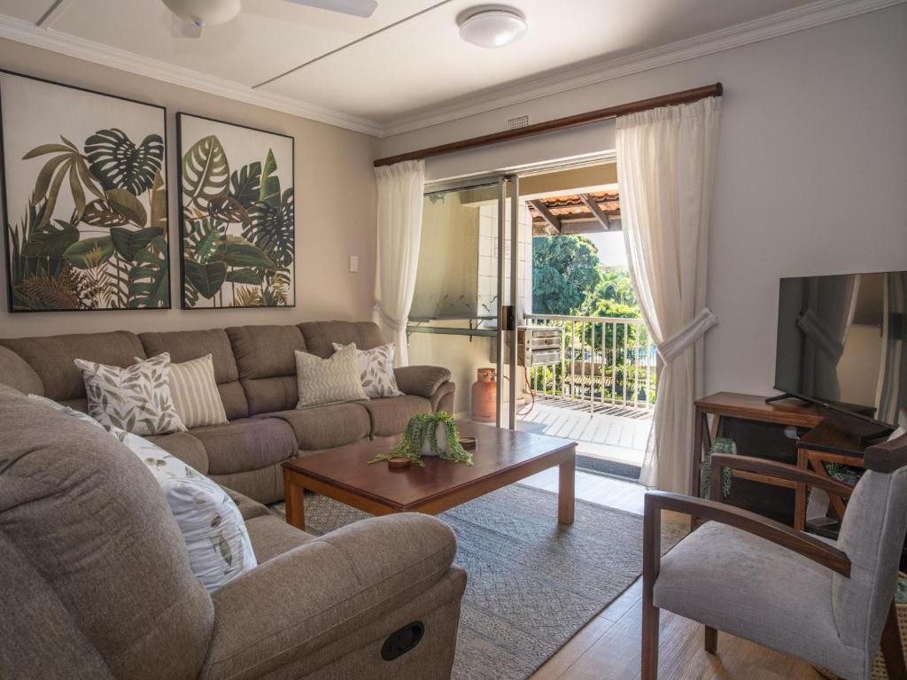 a living room with a couch and a table at Lakeview Cabanas - Unit 11 in St Lucia
