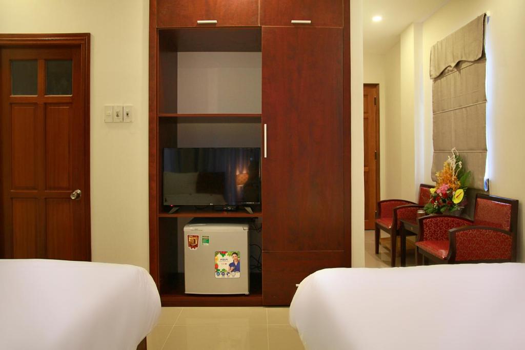 Postel nebo postele na pokoji v ubytování Danang Classic Hotel