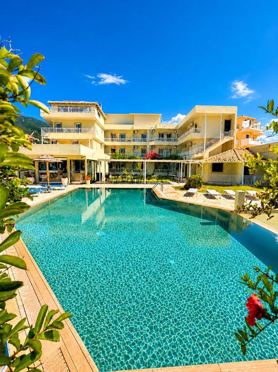 a large swimming pool in front of a building at Kalias Hotel in Vasiliki