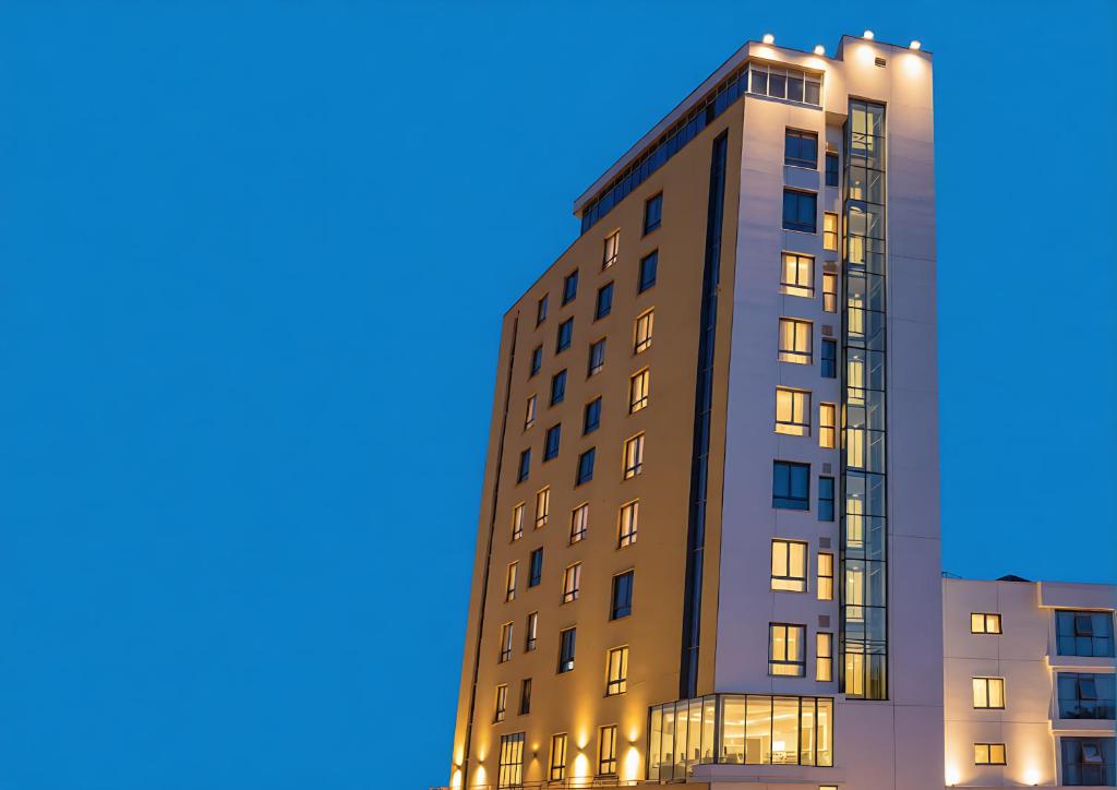 a tall apartment building with its lights on at Transit Hotel in Juba