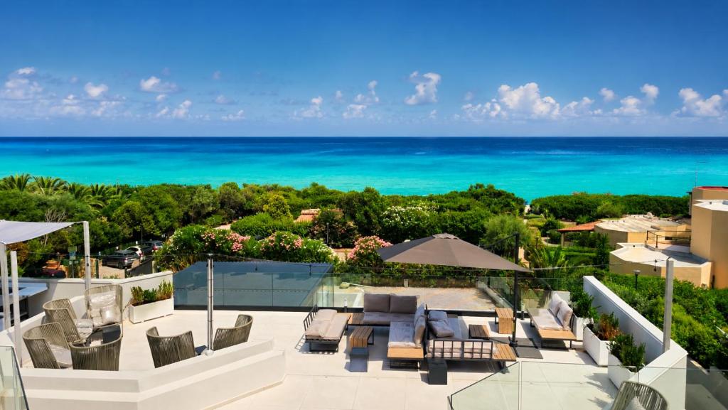 an aerial view of a patio with the ocean in the background at Naim Boutique Hotel in Costa Rei