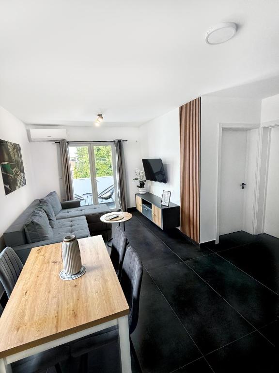 a living room with a table and a couch at Aster Apartments in Belgrade
