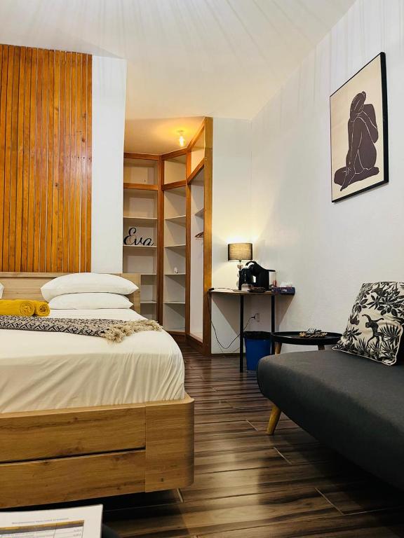 a bedroom with a bed and a desk in it at Moya Résidence by MD in Dzaoudzi