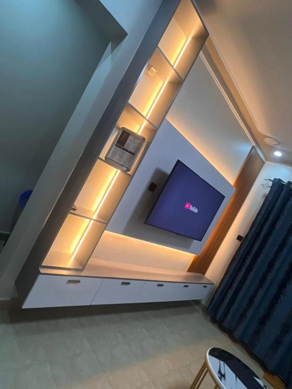 a room with a ceiling with a tv in it at Princess selection suites in Wakiso