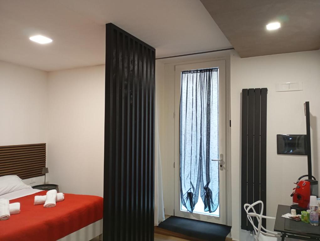 a bedroom with a bed and a window at Borgo Mantova in Potenza