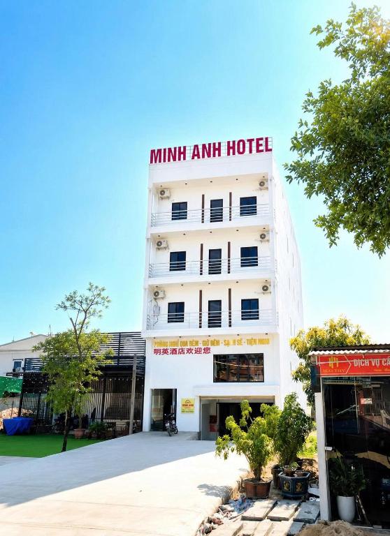 a white hotel with a sign on top of it at Minh Anh Hotel Nghệ An in Vinh