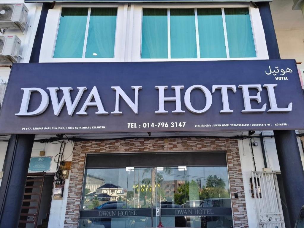 a sign for a van hotel on a building at Dwan Hotel in Kota Bharu