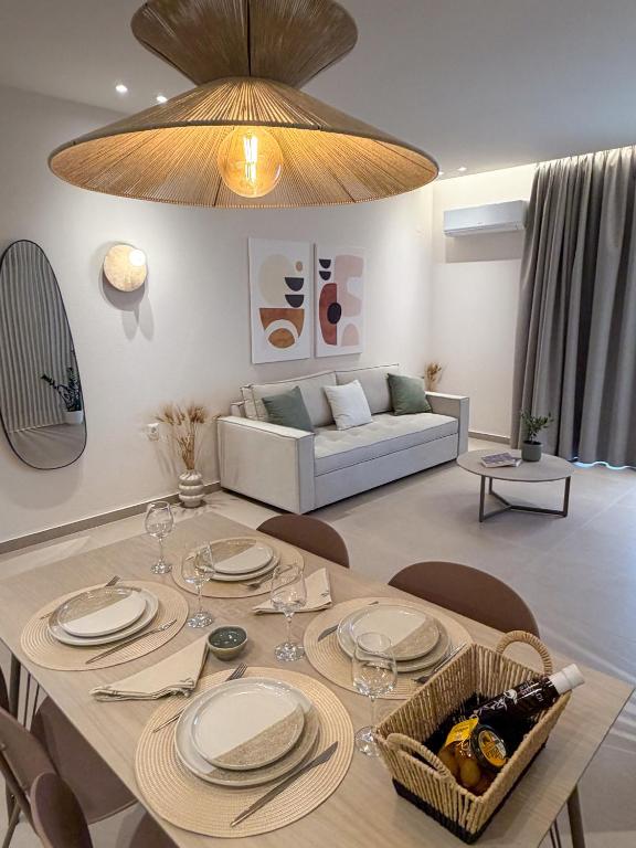 a living room with a table and a couch at Elia Stay in Kalives Poligirou