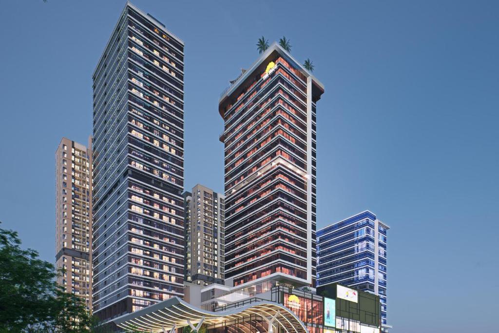 two tall skyscrapers in a city at The Trans Luxury Hotel Surabaya in Surabaya