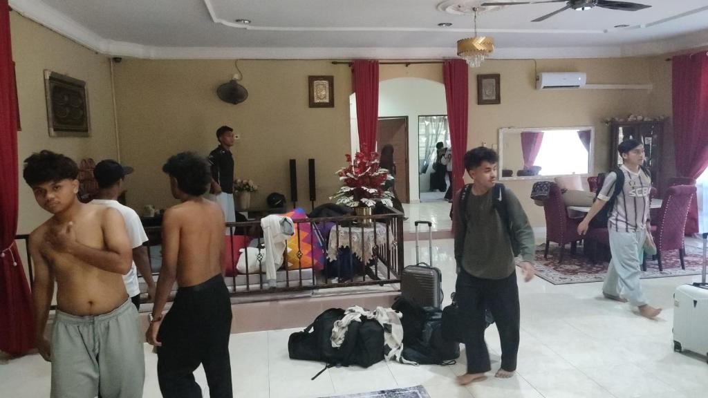 a group of young men standing in a room at Villa Cempaka II in Changlun