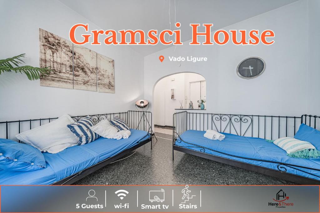 two twin beds in a room with a banner at Gramsci House - Sea 3 min - Central - Family in Vado Ligure
