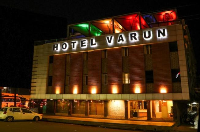 a hotel venna building with a white car parked in front at Hotel Varun in Guna