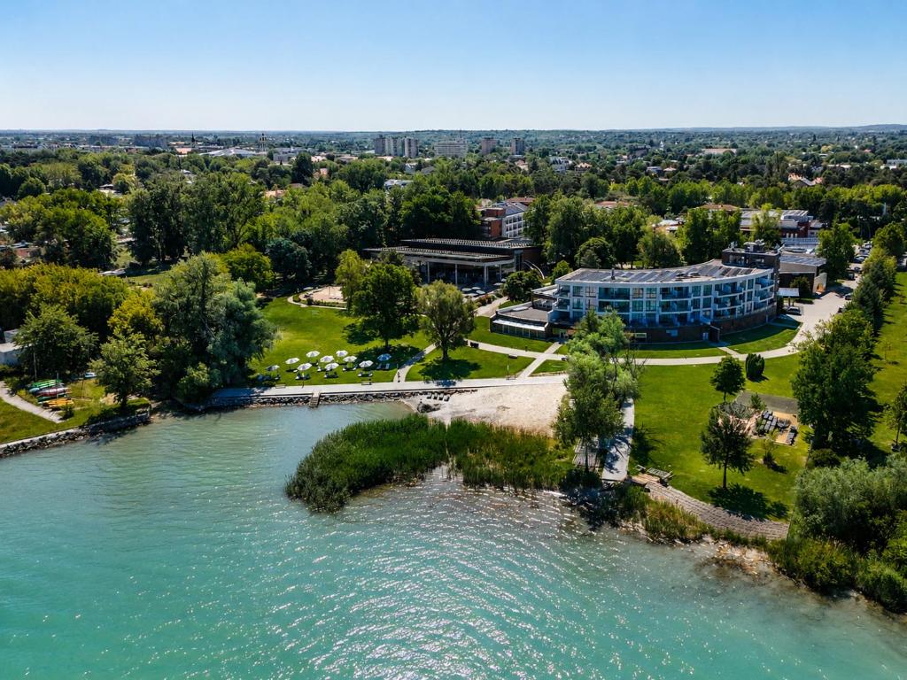 an aerial view of a resort next to a river at Hotel Azur Premium in Siófok