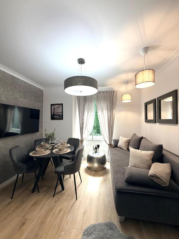 a living room with a couch and a table at Pokład Jurata in Jurata