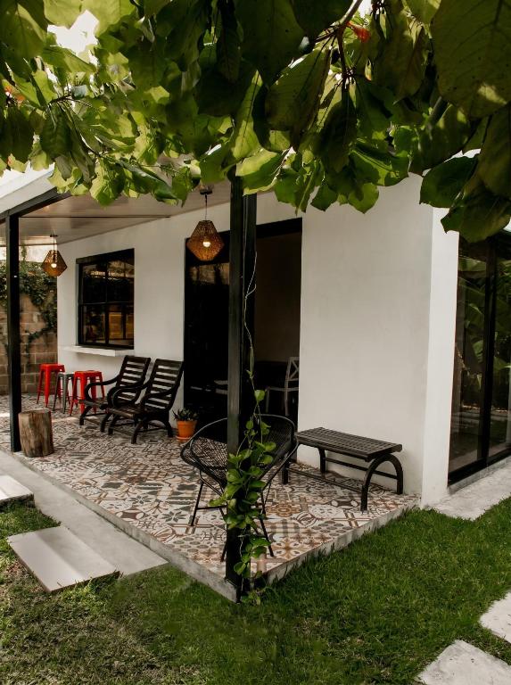 a patio with a group of chairs and a table at Villa Palmarcito in El Zonte
