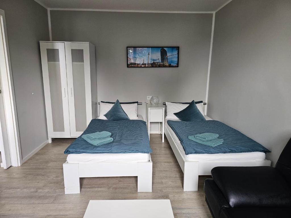 a living room with two beds and a couch at Apartment mea in Berlin